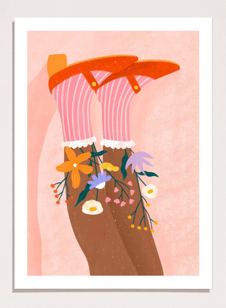 A stylized art print featuring a pair of legs wearing pink striped socks with white ruffles, decorated with colorful wildflowers, and topped with orange high-heeled shoes, set against a textured pink background. Happy Feet and Flowers by Bea Müller premium framed fine art print featuring red Mary Janes, striped socks, and colorful flowers on a soft pink background.