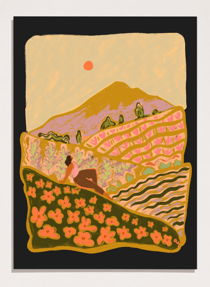 Illustration of a person sitting on a hill with a mountain and sunset in the background. Field Of Flowers by Arty Guava is a colorful landscape art print featuring blooming fields, rolling hills, nature-inspired illustration, and contemporary wall art.