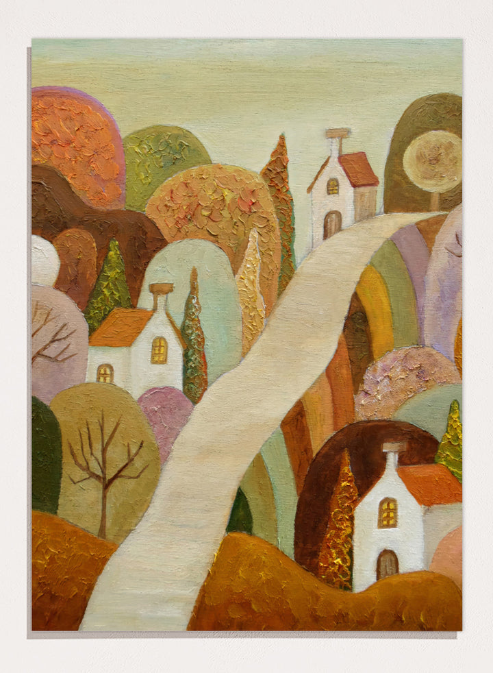 A stylized landscape painting featuring small white houses with orange roofs, rolling hills in earthy tones, and a pale winding path through the scene. Shop Whimsical Village Path by Angeles M. Pomata, an autumn landscape art print featuring a winding road, white village houses, rounded hills, and warm earthy tones.