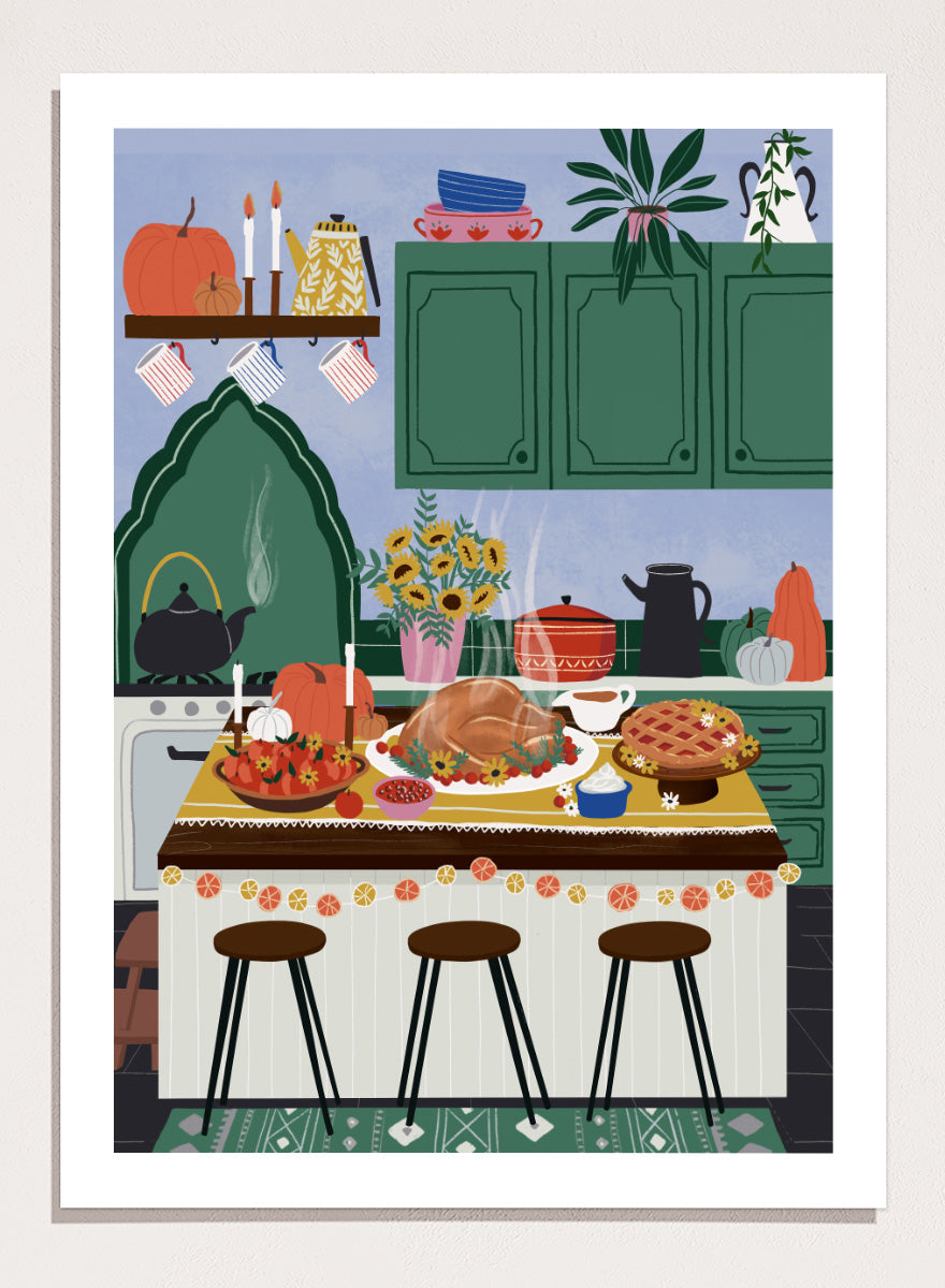 A framed art print depicting a cozy, stylized autumn kitchen scene with a large roasted turkey on a table covered in fall dishes, green cabinets, pumpkins, and three bar stools. Cozy Thanksgiving Kitchen by Ceyda Alasar kitchen art print featuring a turkey feast, pie, pumpkins, flowers, candles, and warm autumn decor.