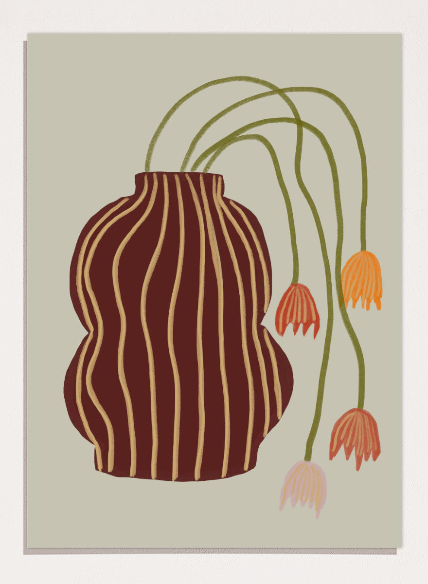A stylized botanical art print featuring a dark brown vase with vertical gold stripes and several trailing flowers in orange, pink, and olive green on a warm beige background. Striped Vase Drooping Flowers by The Art Concept art print featuring a burgundy striped vase and soft drooping blooms in warm earthy tones.