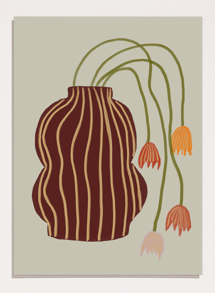 A stylized botanical art print featuring a dark brown vase with vertical gold stripes and several trailing flowers in orange, pink, and olive green on a warm beige background. Striped Vase Drooping Flowers by The Art Concept art print featuring a burgundy striped vase and soft drooping blooms in warm earthy tones.