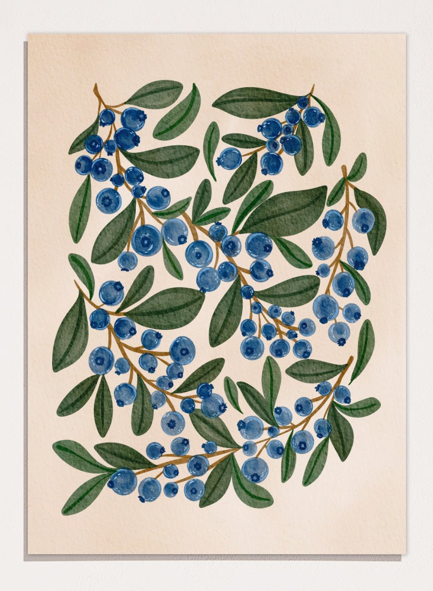 Botanical art print of blueberry branches with green leaves on a warm beige background. Shop Fresh Blueberry Sprigs by Nikita Jariwala, a botanical wall art print poster featuring blueberry branches, deep blue berries, and leafy green summer detail.