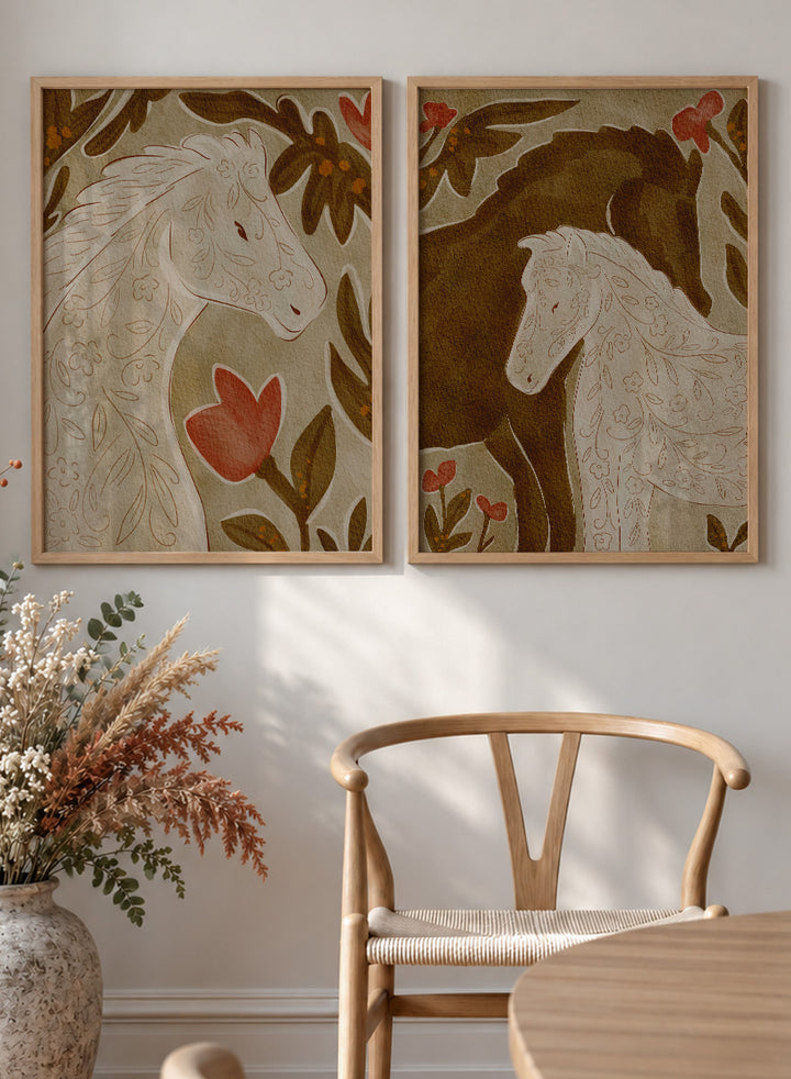 Two framed art prints depicting stylized horses in warm earthy tones. Shop Wildflower Horses by Nikita Jariwala, a set of 2 horse wall art prints posters featuring floral horse portraits, botanical details, and warm brown tones.