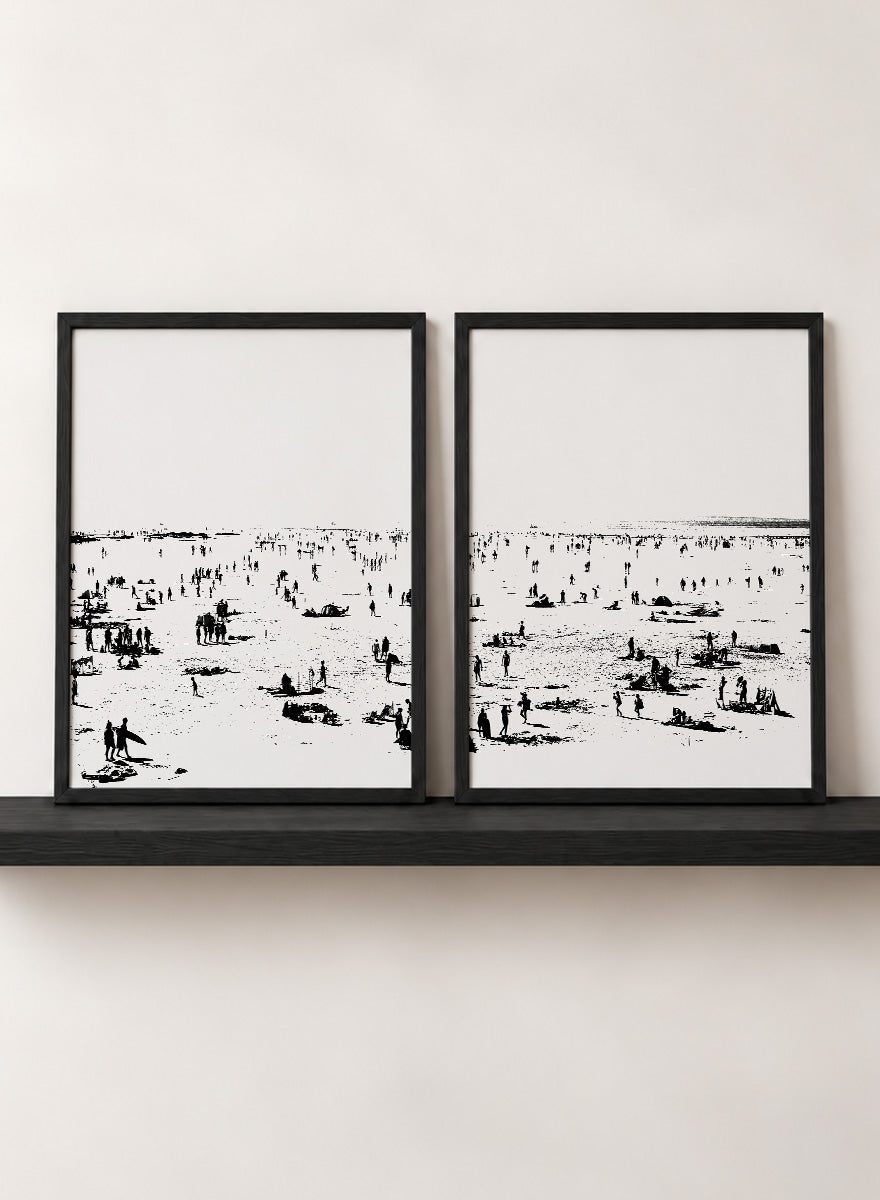 Shop Beach No.02 by Dan Hobday, a set of 2 black and white beach wall art prints posters featuring a panoramic shoreline filled with tiny figures.