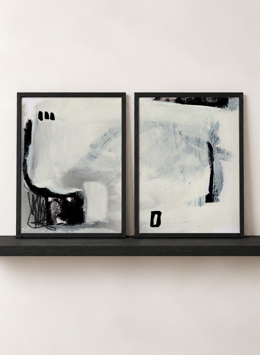 Shop Beyond by Dan Hobday, a set of 2 abstract wall art prints posters featuring expressive black forms, layered brushwork, and soft white and blue tones.
