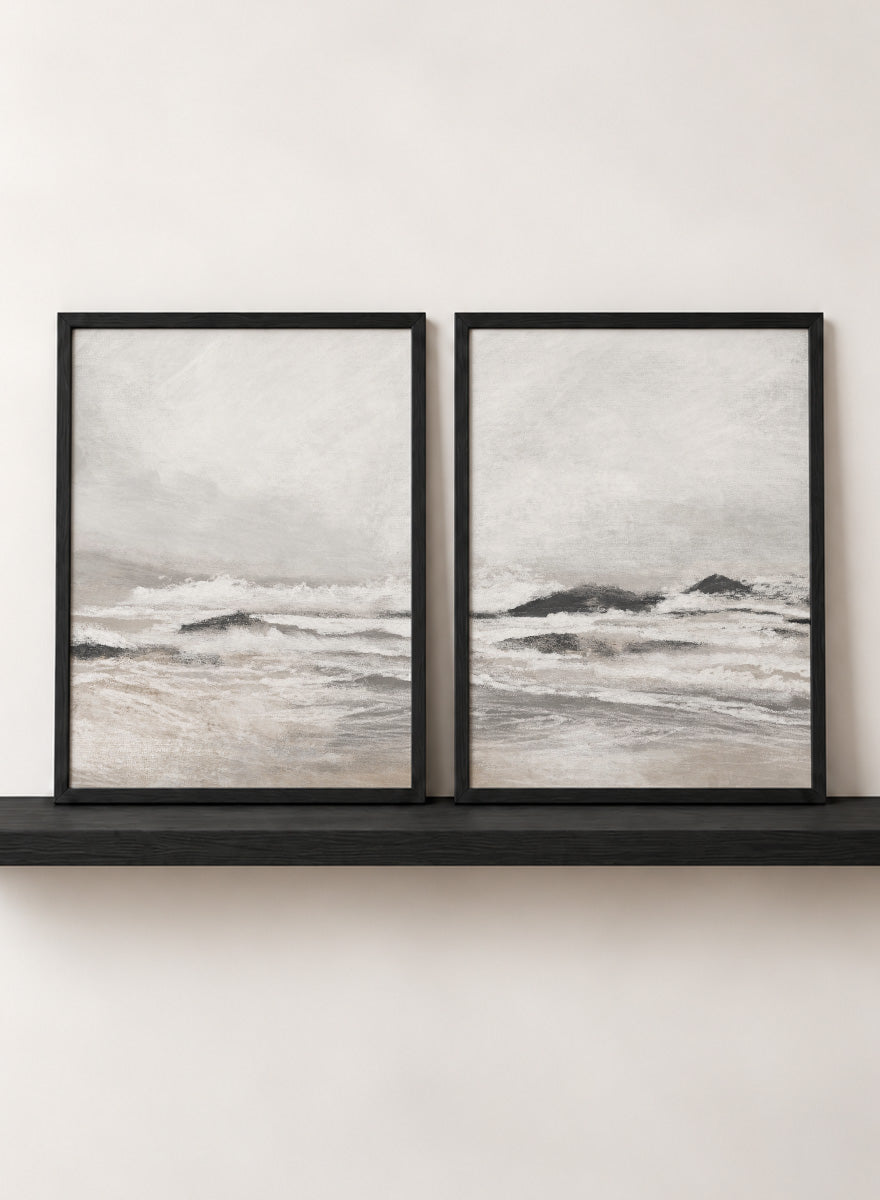 Shop September Coast by Dan Hobday, a set of 2 coastal wall art prints posters featuring rolling waves, dark rocks, misty skies, and soft neutral tones.