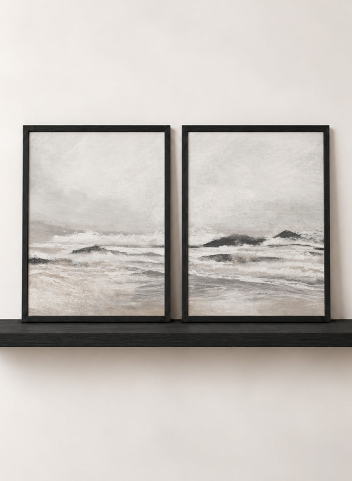 Shop September Coast by Dan Hobday, a set of 2 coastal wall art prints posters featuring rolling waves, dark rocks, misty skies, and soft neutral tones.