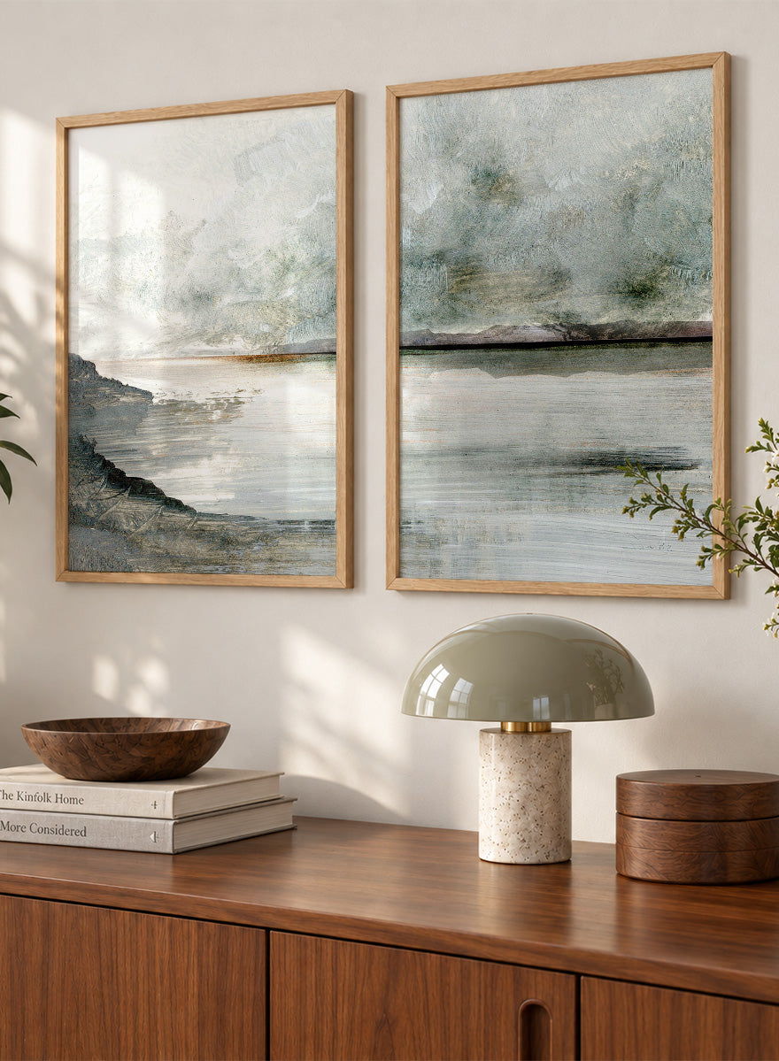 Shop Still Coast by Dan Hobday, a set of 2 coastal landscape wall art prints posters featuring misty water, rocky shoreline, and soft gray and green tones.