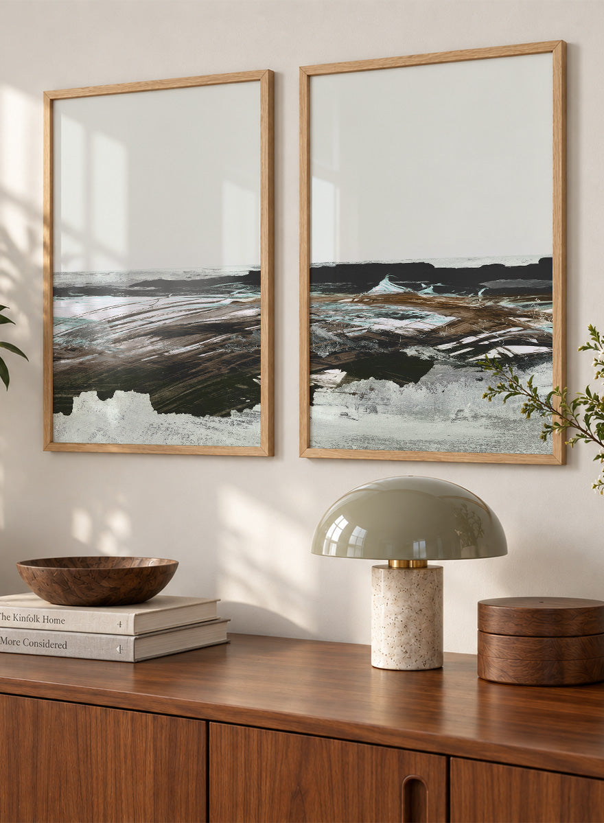 Shop Constantine Bay by Dan Hobday, a set of 2 coastal landscape wall art prints posters featuring windswept shoreline, surf, and muted blue-brown tones.