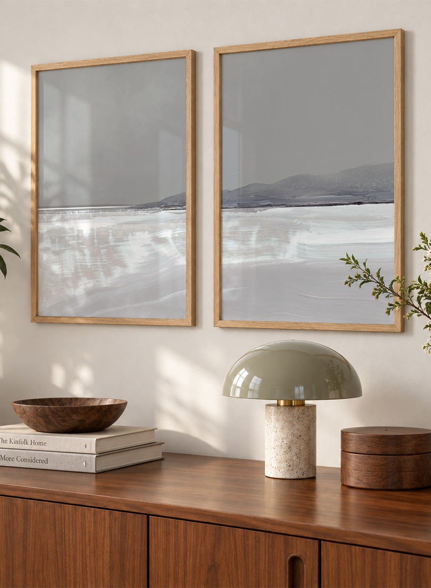 Shop Tides by Dan Hobday, a set of 2 coastal landscape wall art prints posters featuring calm water, distant hills, and soft gray-blue tones.