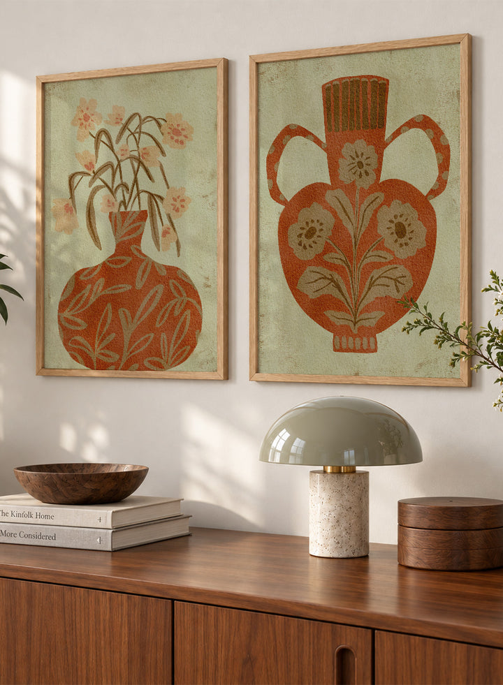 Shop Terracotta Floral Vases by Nikita Jariwala, a set of 2 botanical wall art prints posters featuring floral vase artwork in warm orange tones.