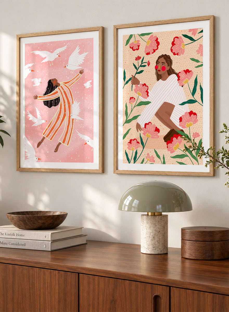 Shop In Her Happy Place by Bea Müller, a set of 2 figurative wall art prints posters featuring women surrounded by birds and flowers in soft pink tones.