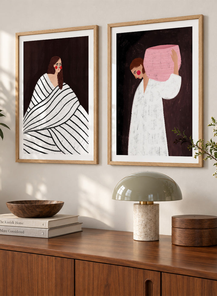 Shop In Her Own World by Bea Müller, a set of 2 figurative wall art prints posters featuring modern women, bold stripes, pink accents, and rich brown tones.