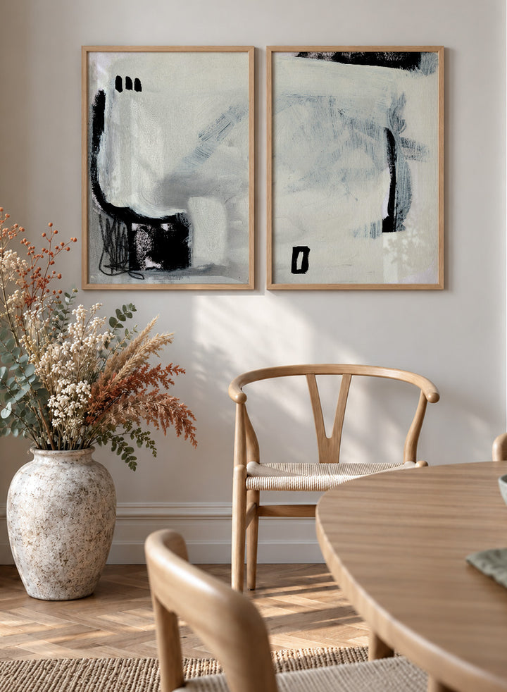 Shop Beyond by Dan Hobday, a set of 2 abstract wall art prints posters featuring expressive black forms, layered brushwork, and soft white and blue tones.