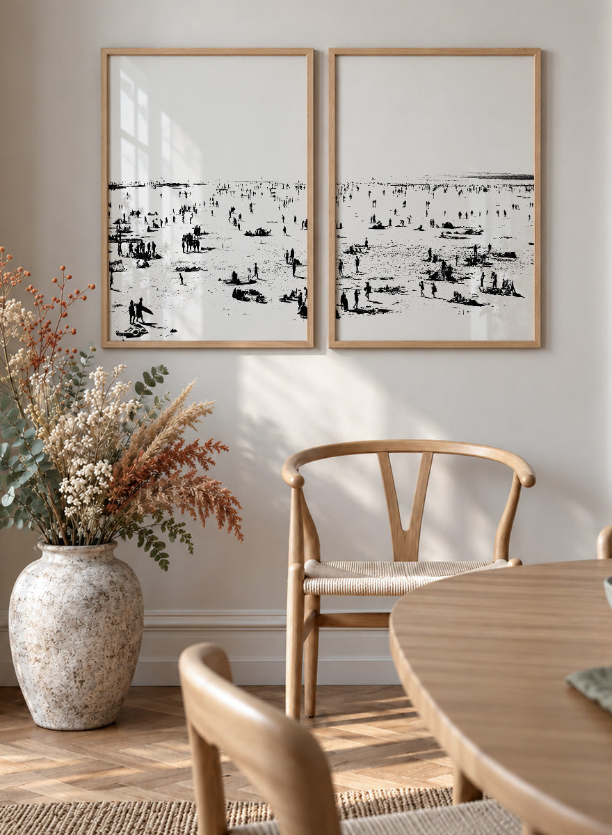 Shop Beach No.02 by Dan Hobday, a set of 2 black and white beach wall art prints posters featuring a panoramic shoreline filled with tiny figures.