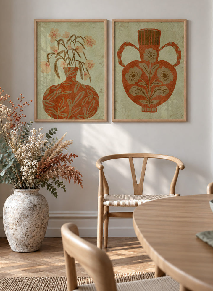 Shop Terracotta Floral Vases by Nikita Jariwala, a set of 2 botanical wall art prints posters featuring floral vase artwork in warm orange tones.