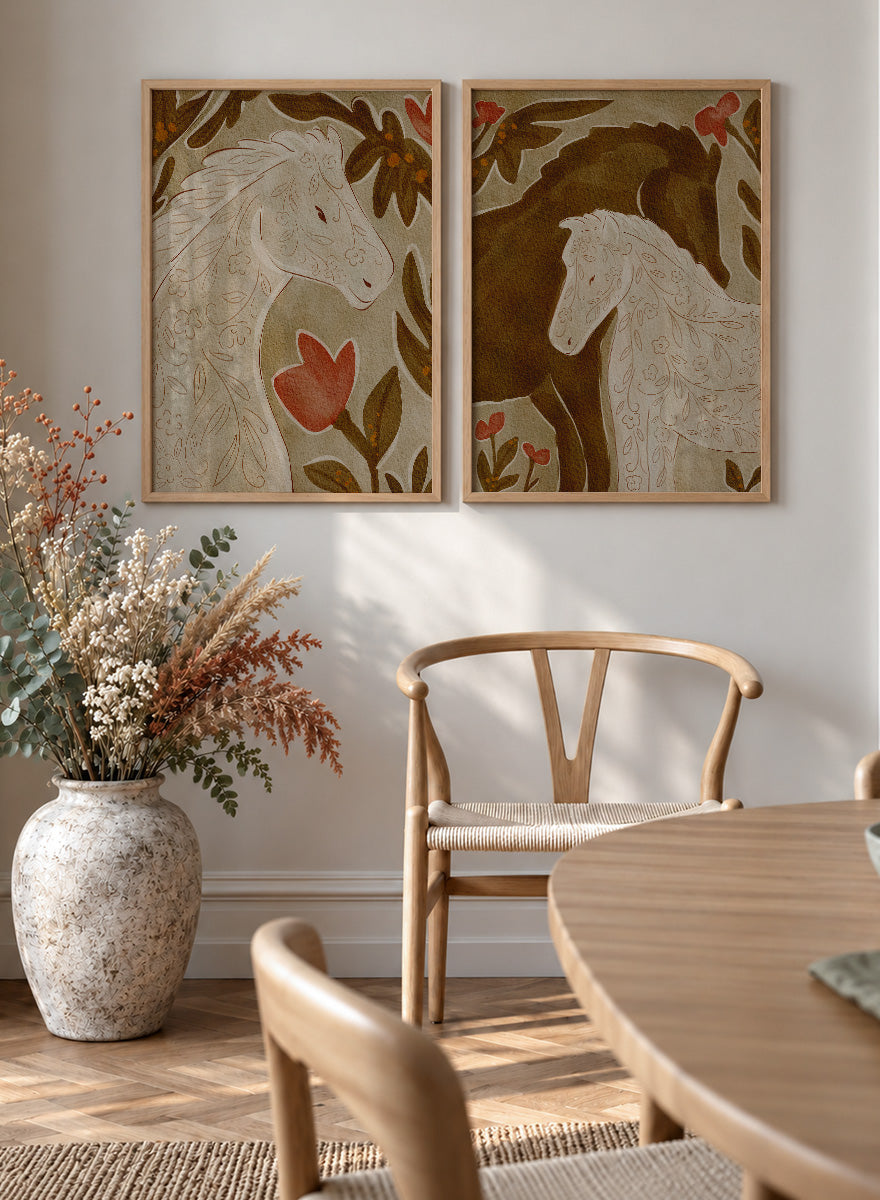 Two framed art prints depicting stylized horses in warm earthy tones. Shop Wildflower Horses by Nikita Jariwala, a set of 2 horse wall art prints posters featuring floral horse portraits, botanical details, and warm brown tones.