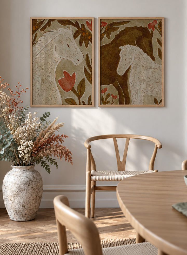 Two framed art prints depicting stylized horses in warm earthy tones. Shop Wildflower Horses by Nikita Jariwala, a set of 2 horse wall art prints posters featuring floral horse portraits, botanical details, and warm brown tones.