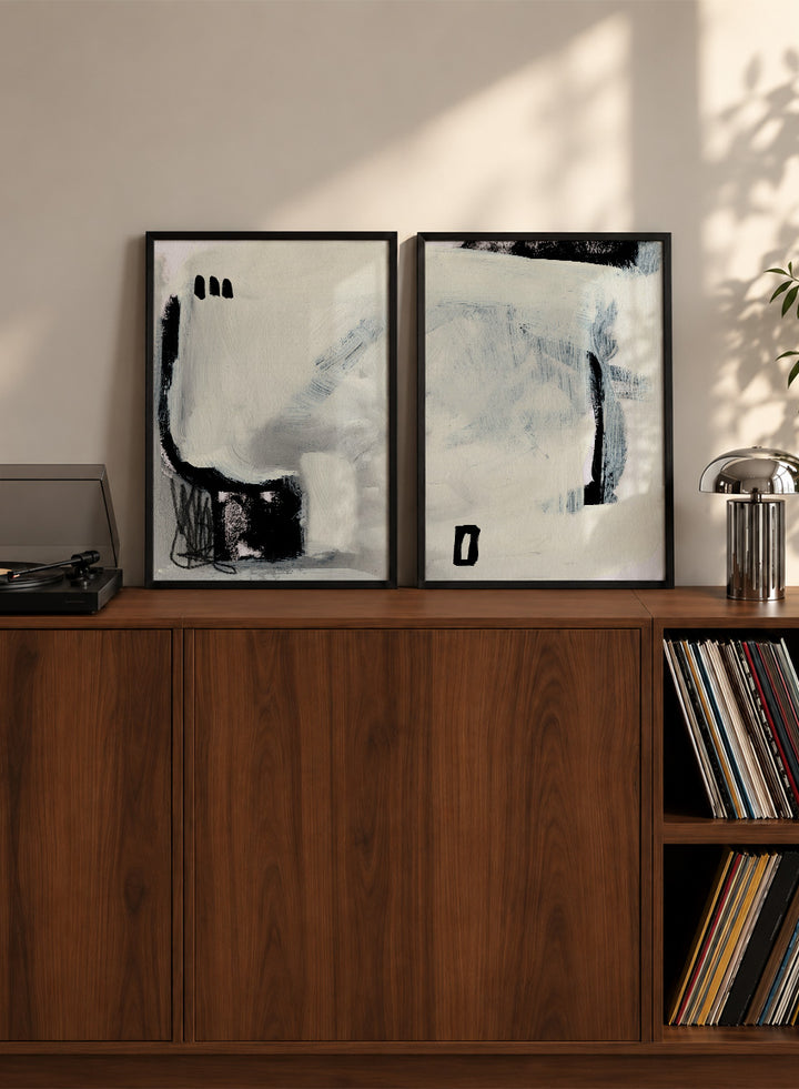 Shop Beyond by Dan Hobday, a set of 2 abstract wall art prints posters featuring expressive black forms, layered brushwork, and soft white and blue tones.