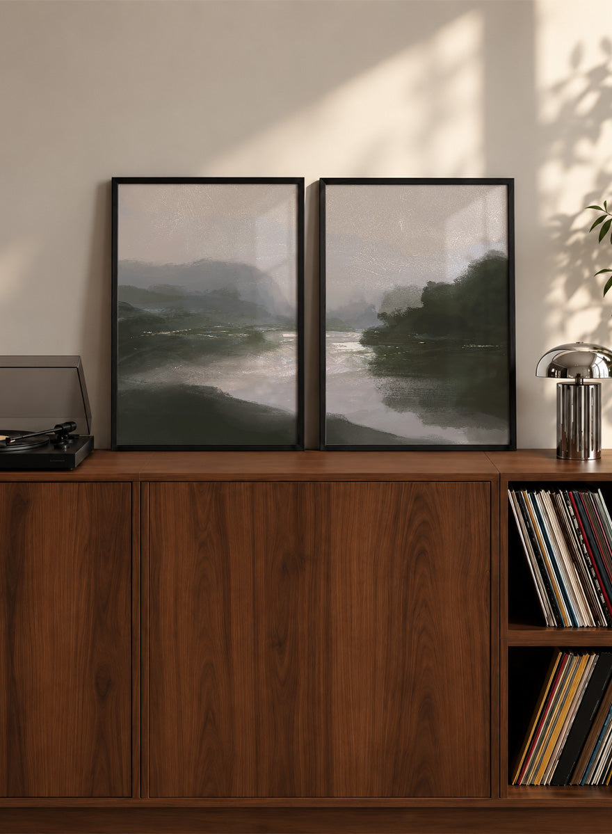 Shop Tranquillitas by Dan Hobday, a set of 2 landscape wall art prints posters featuring misty water, tree-lined banks, distant hills, and deep grey green tones.