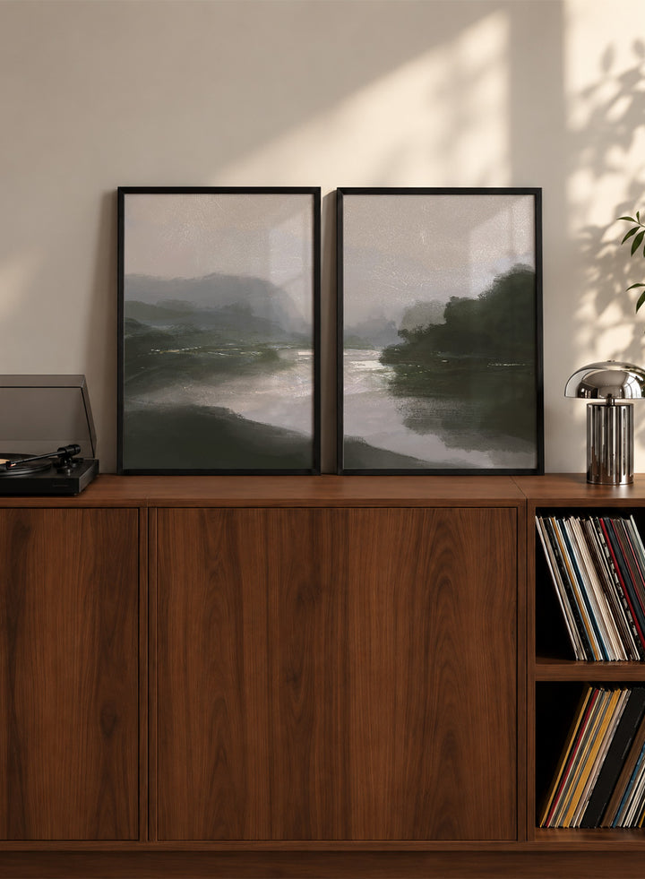 Shop Tranquillitas by Dan Hobday, a set of 2 landscape wall art prints posters featuring misty water, tree-lined banks, distant hills, and deep grey green tones.