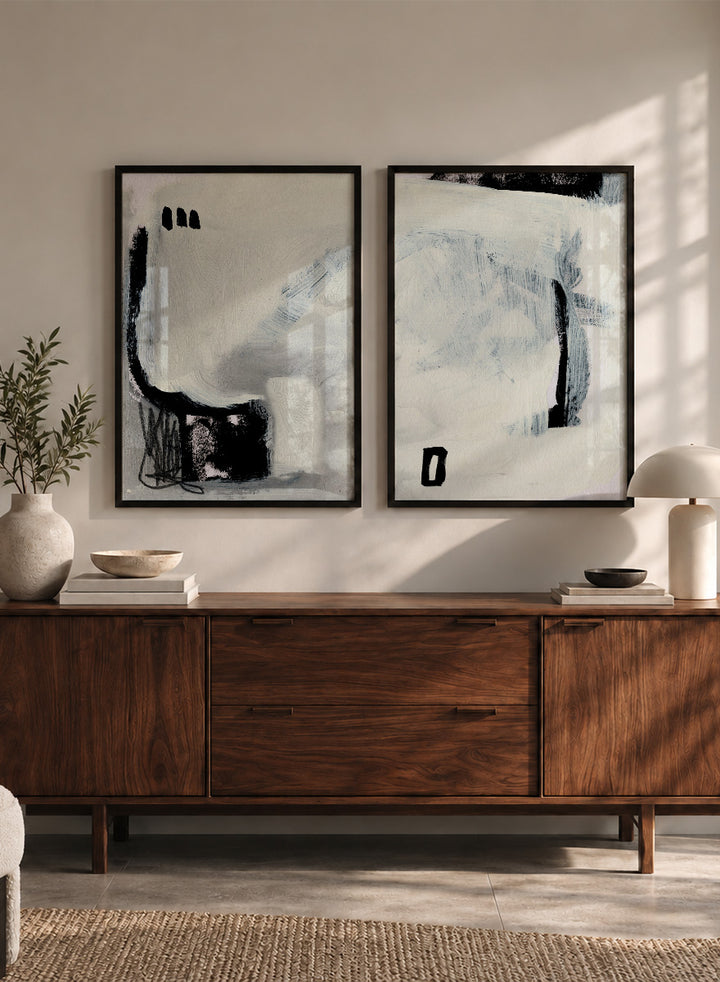 Shop Beyond by Dan Hobday, a set of 2 abstract wall art prints posters featuring expressive black forms, layered brushwork, and soft white and blue tones.