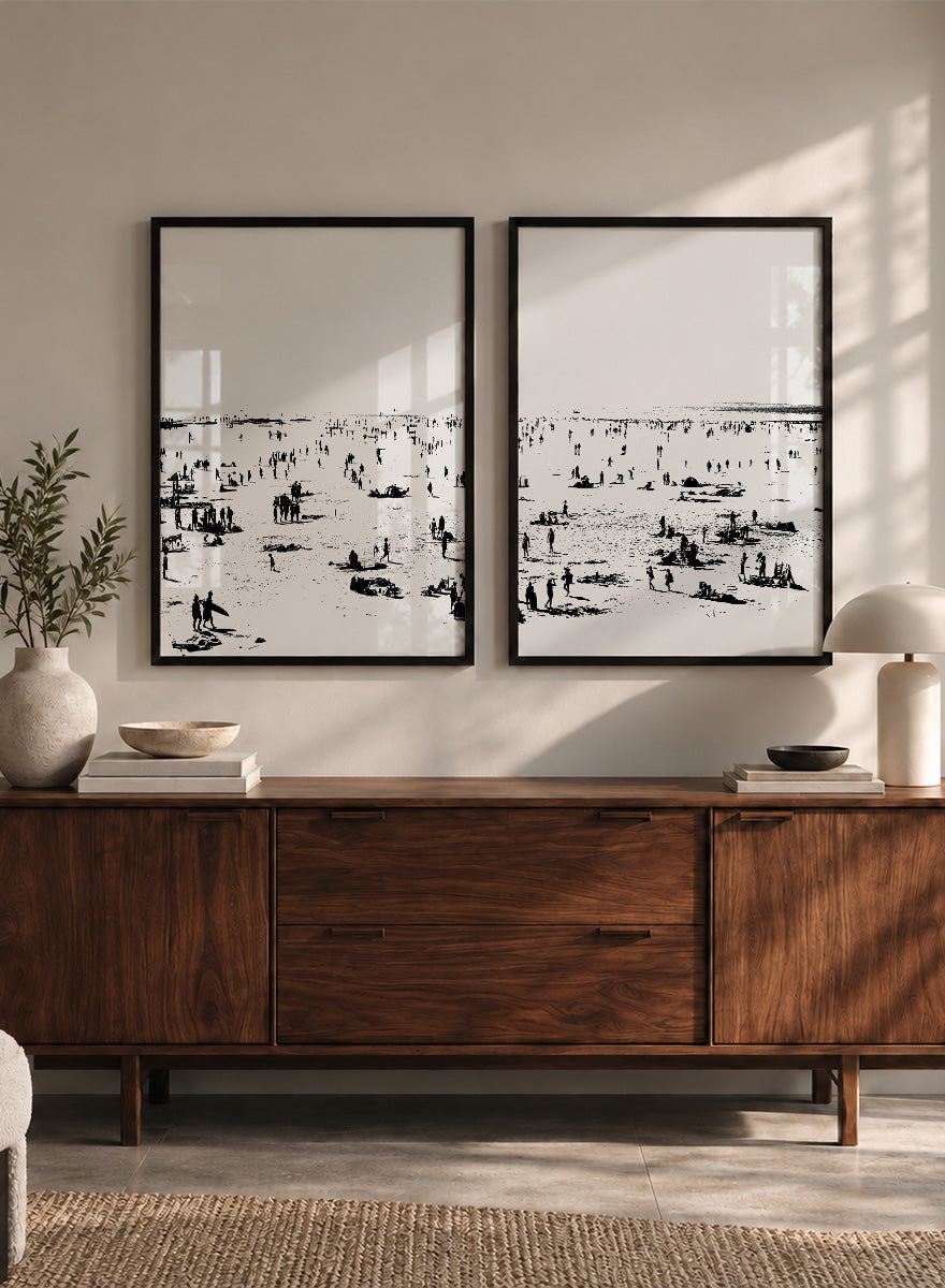 Shop Beach No.02 by Dan Hobday, a set of 2 black and white beach wall art prints posters featuring a panoramic shoreline filled with tiny figures.