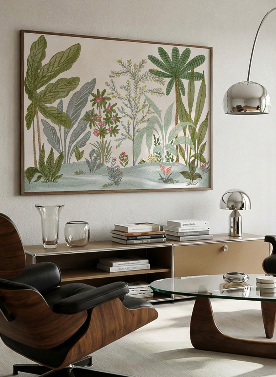 A framed botanical art print featuring a collection of tropical and jungle plants in muted green, gray, and soft pink tones on a cream background. Shop Lush Tropical Jungle by Nikita Jariwala, a tropical botanical wall art print poster with jungle plants, palm leaves, layered foliage, and green tones.