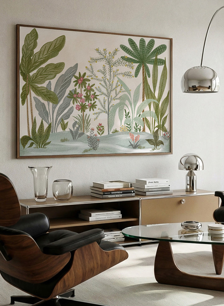 A framed botanical art print featuring a collection of tropical and jungle plants in muted green, gray, and soft pink tones on a cream background. Shop Lush Tropical Jungle by Nikita Jariwala, a tropical botanical wall art print poster with jungle plants, palm leaves, layered foliage, and green tones.