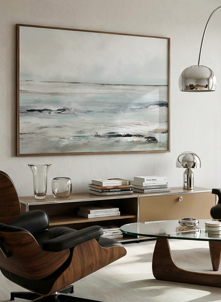 Shop Sandy Bay by Dan Hobday, a coastal landscape art print featuring soft blue-gray water, pale sky, textured shoreline, and layered neutral brushwork.