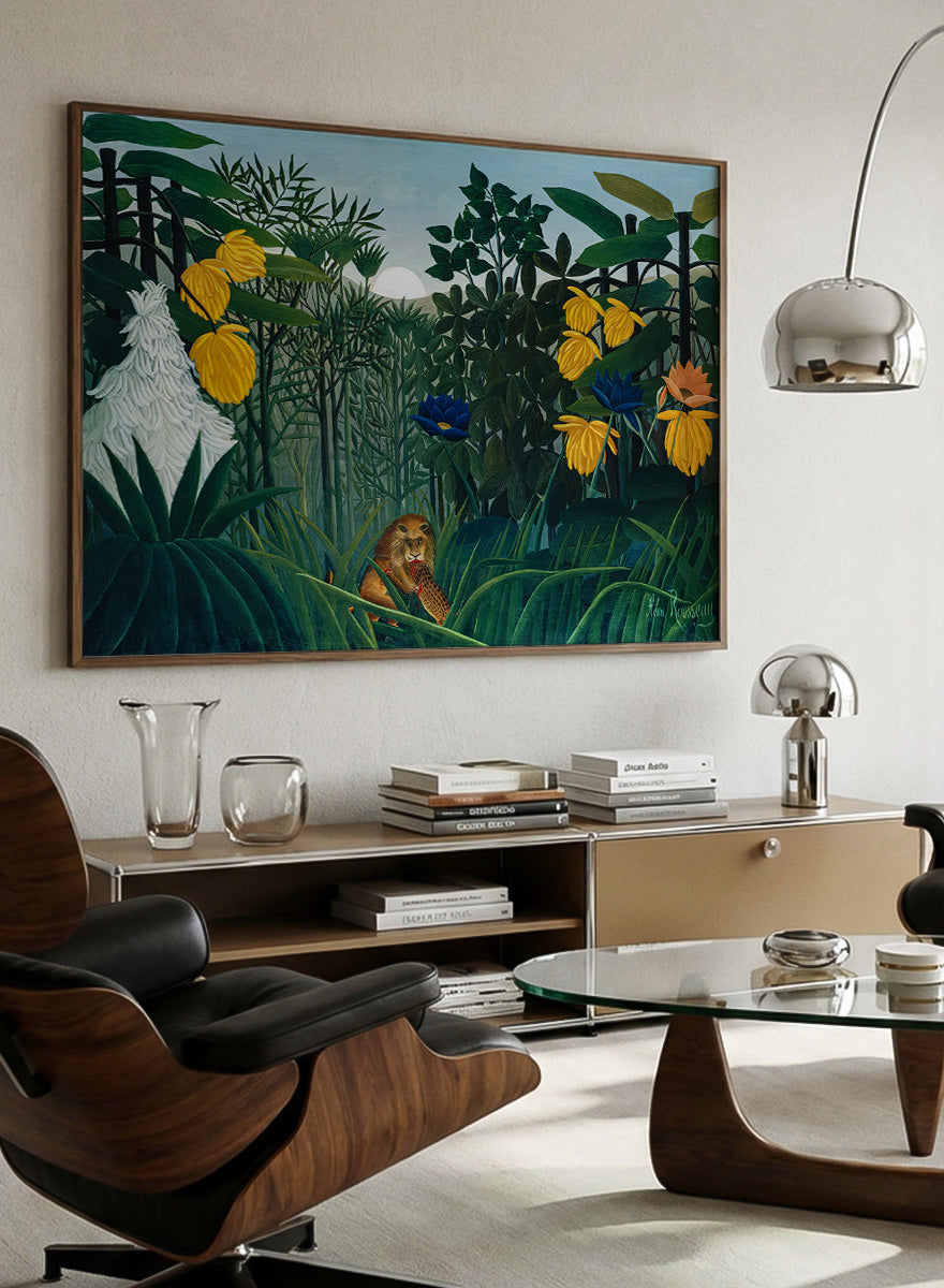A framed art print depicting a lush jungle scene with green foliage, yellow flowers, blue and orange blossoms, and a small lion near the bottom center. The Repast of the Lion by Henri Rousseau is a vintage jungle art print featuring a lion hidden among dense tropical foliage and lush green plants.