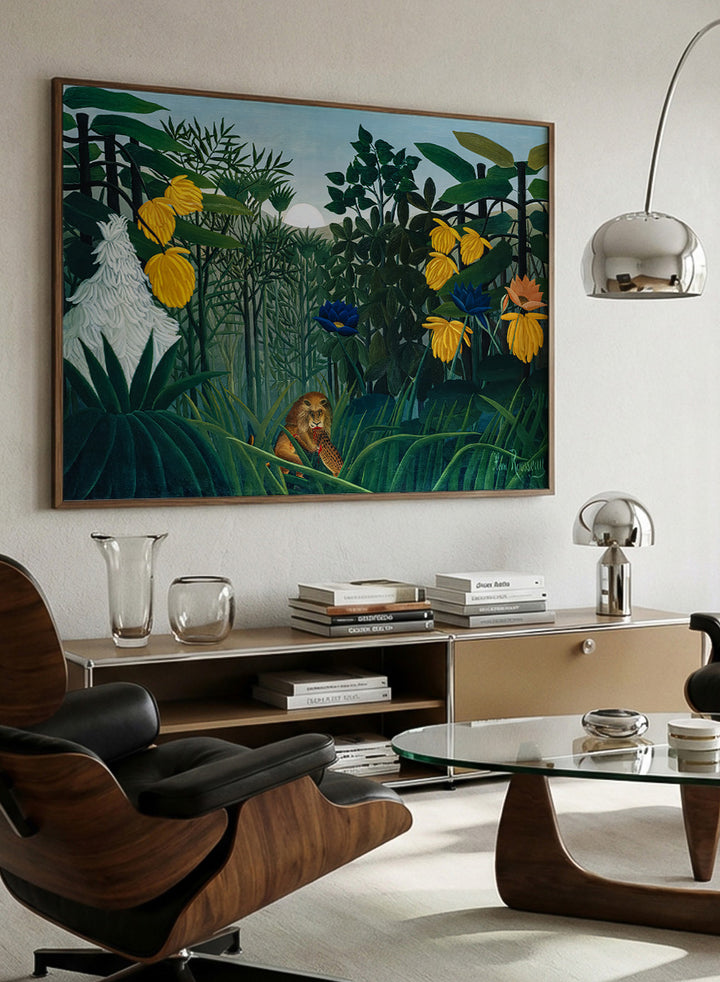 A framed art print depicting a lush jungle scene with green foliage, yellow flowers, blue and orange blossoms, and a small lion near the bottom center. The Repast of the Lion by Henri Rousseau is a vintage jungle art print featuring a lion hidden among dense tropical foliage and lush green plants.