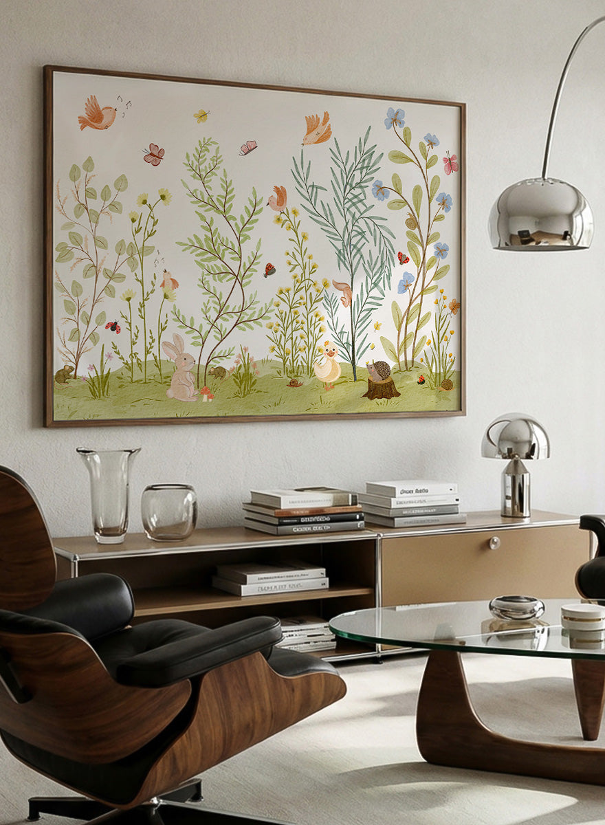 A framed art print featuring a whimsical, watercolor-style illustration of a garden with birds, butterflies, flowers, rabbits, and small animals on a light cream background. Shop Woodland Animal Friends by Nikita Jariwala, a woodland animal wall art print poster with rabbit, duck, hedgehog, butterflies, flowers, and green tones.