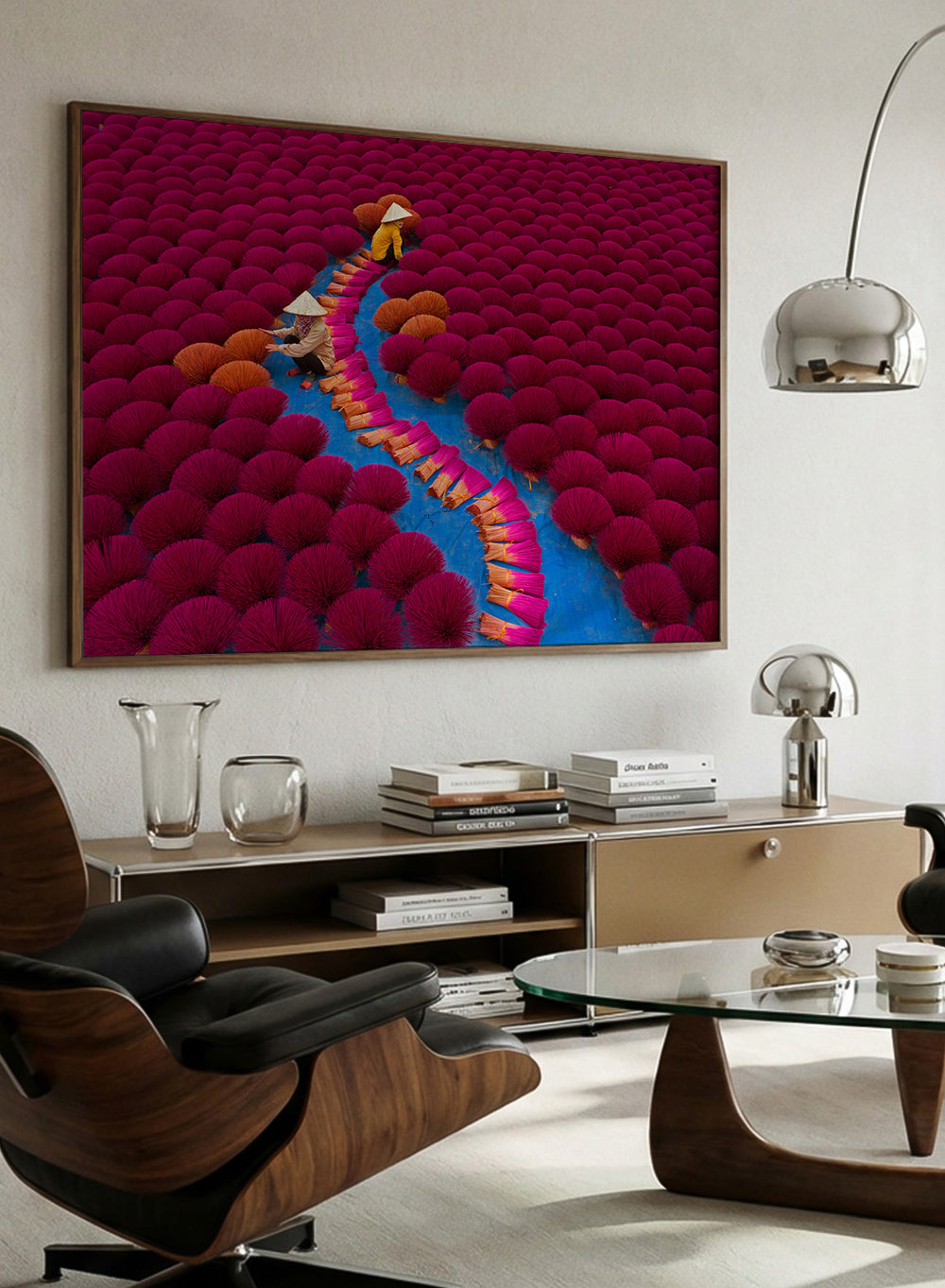 Two people walking through a field of red incense sticks with a clear sky. Drying Incense by Azim Khan Ronnie photography print showing Vietnamese incense workers in Hanoi with vibrant red bundles, cultural documentary wall art poster