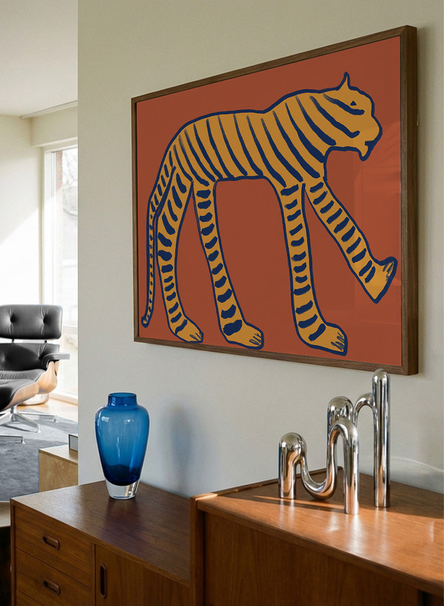 Bold Tiger Stride by The Art Concept animal art print featuring an ochre tiger with deep blue stripes on a warm rust background.