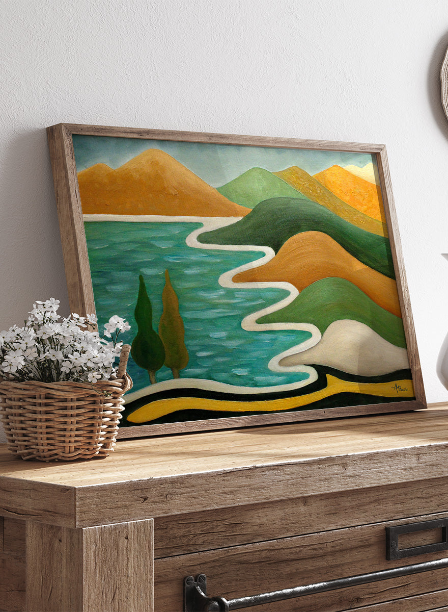 A framed landscape painting featuring stylized green hills, orange mountains, a winding white path, and a turquoise blue body of water with two dark green trees. Shop Abstract River Landscape by Angeles M. Pomata, a colorful abstract landscape art print featuring winding water, rolling hills, and bold earthy tones.