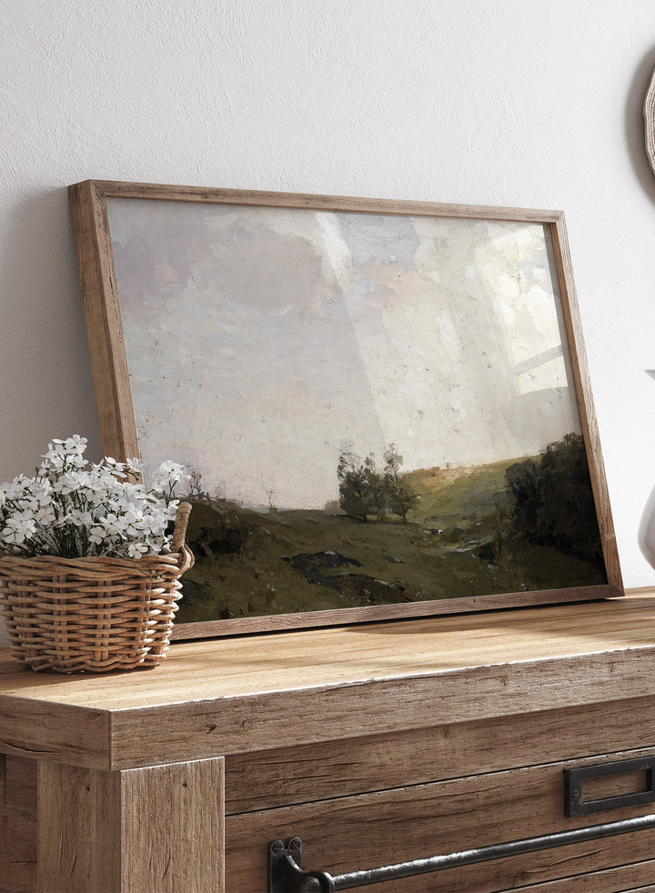 The Three Trees by William Langson Lathrop is a vintage tonalist landscape print of a green field and cloudy sky, a calming countryside wall art print.