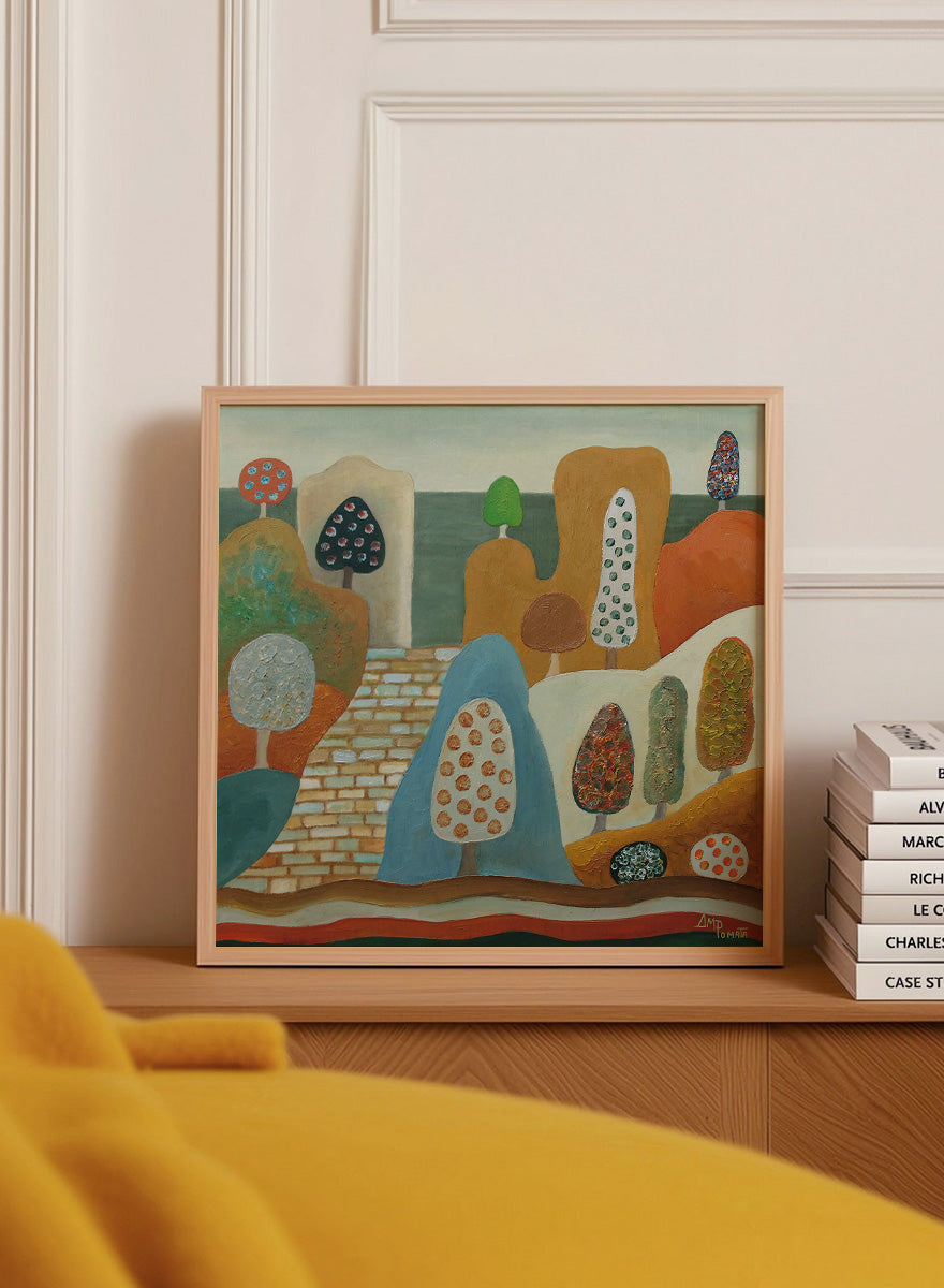 A framed abstract landscape painting featuring stylized trees, hills, and geometric forms in earthy tones of orange, blue, beige, green, and brown. Shop Whimsical Tree Landscape by Angeles M. Pomata, a colorful landscape art print featuring patterned trees, rounded hills, and a winding stone path.
