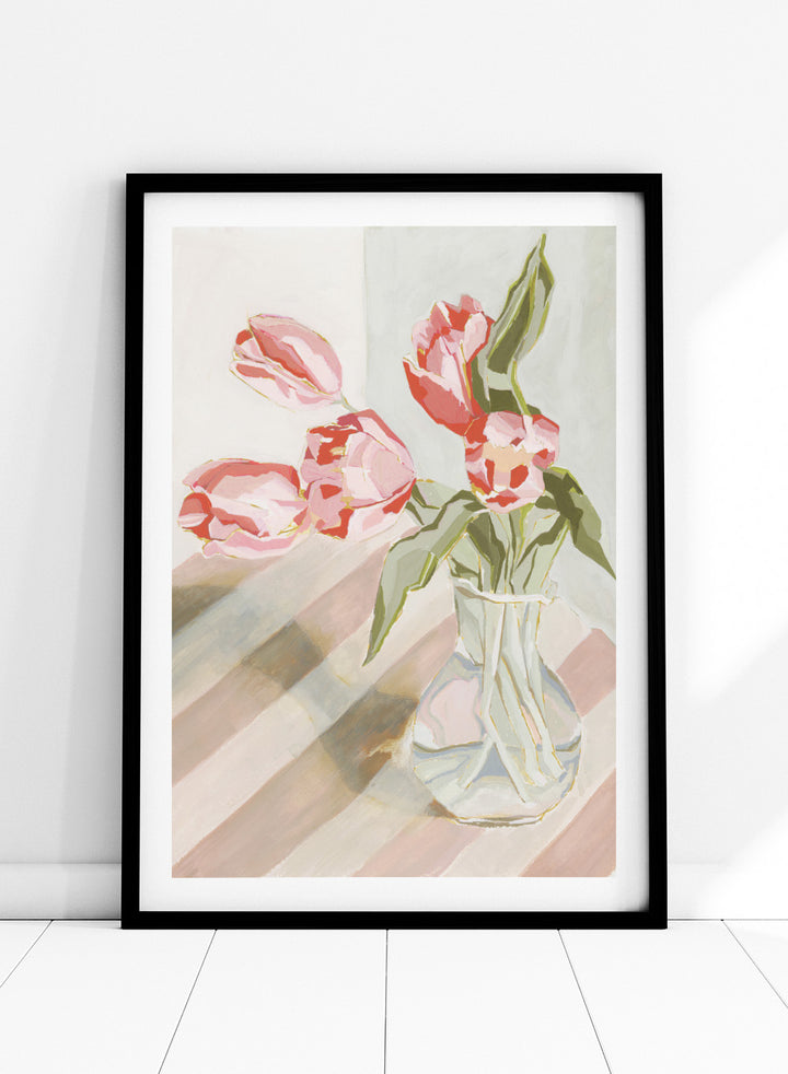 Artistic depiction of pink tulips in a clear vase on a striped background. Tulips in a Vase by Lucrecia Caporale is an officially licensed still life art print featuring pink tulips in a glass vase. Available framed or unframed.