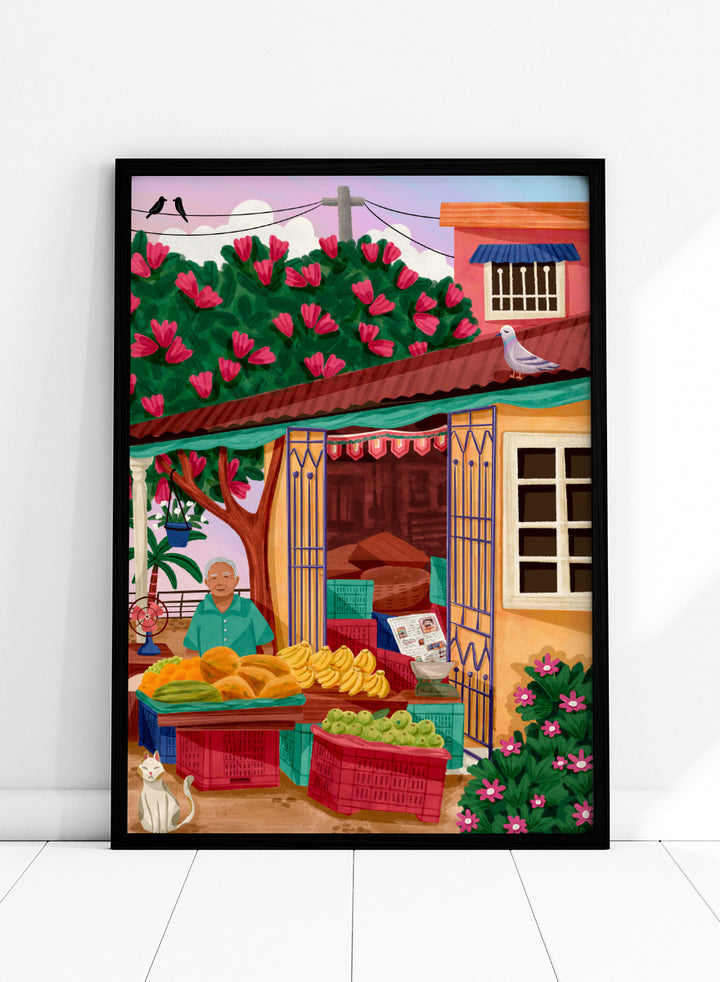 A colorful illustrated street market scene with a vendor standing behind tables of fruit and vegetables, a flowering tree, a house with pink flowers, crates, a pigeon on the roof, birds in the sky, and a white cat in the lower left. Colorful fruit stand art print by Nidhi Kachhadiya with fresh produce, floral details, and market charm. A cheerful print for kitchen or dining spaces.