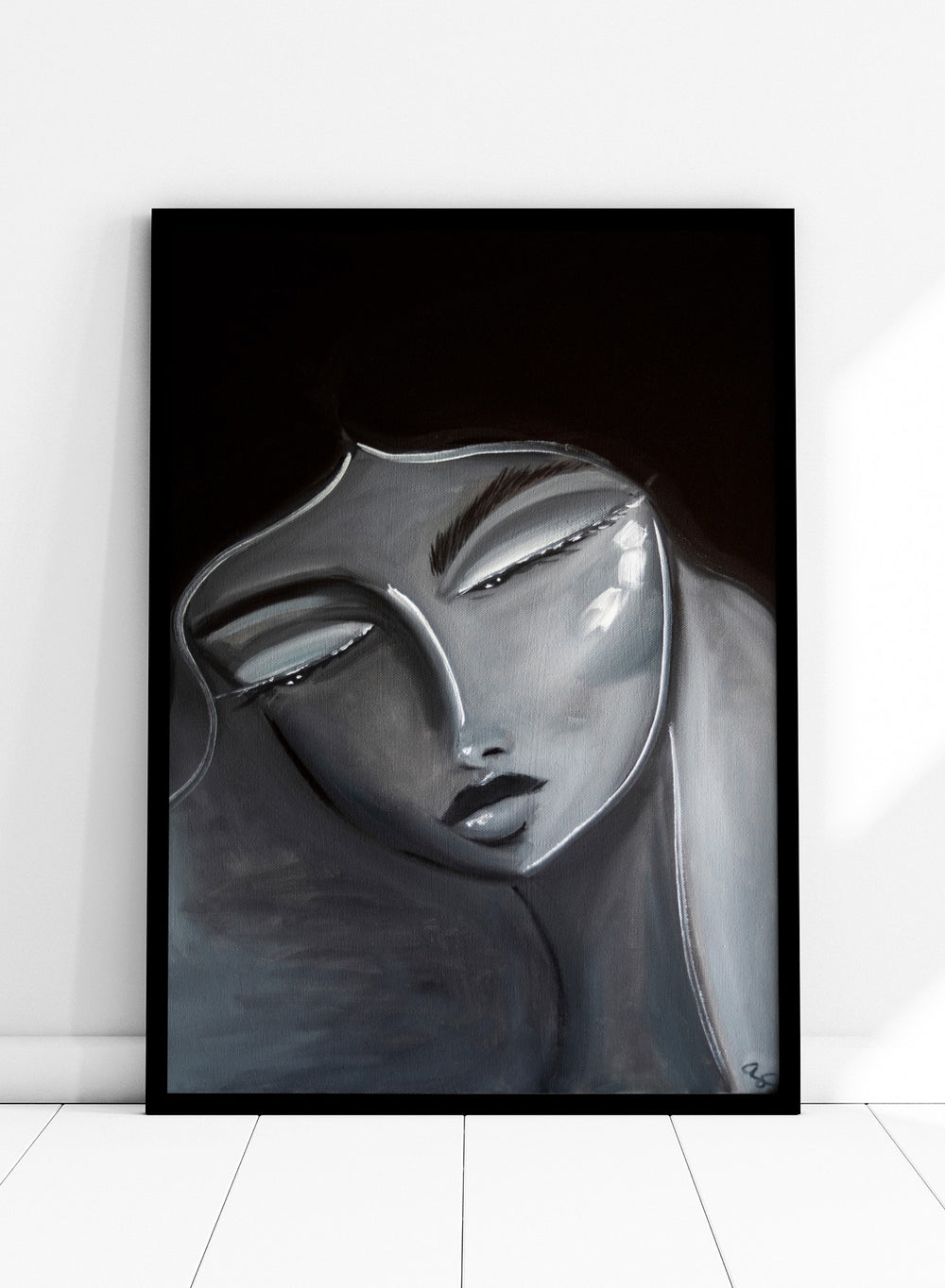 Artistic depiction of a stylized face with long hair on a dark background. Serene Woman Portrait by Amy Straley is a contemporary figurative art print featuring a monochromatic female portrait in soft grey and silver tones.
