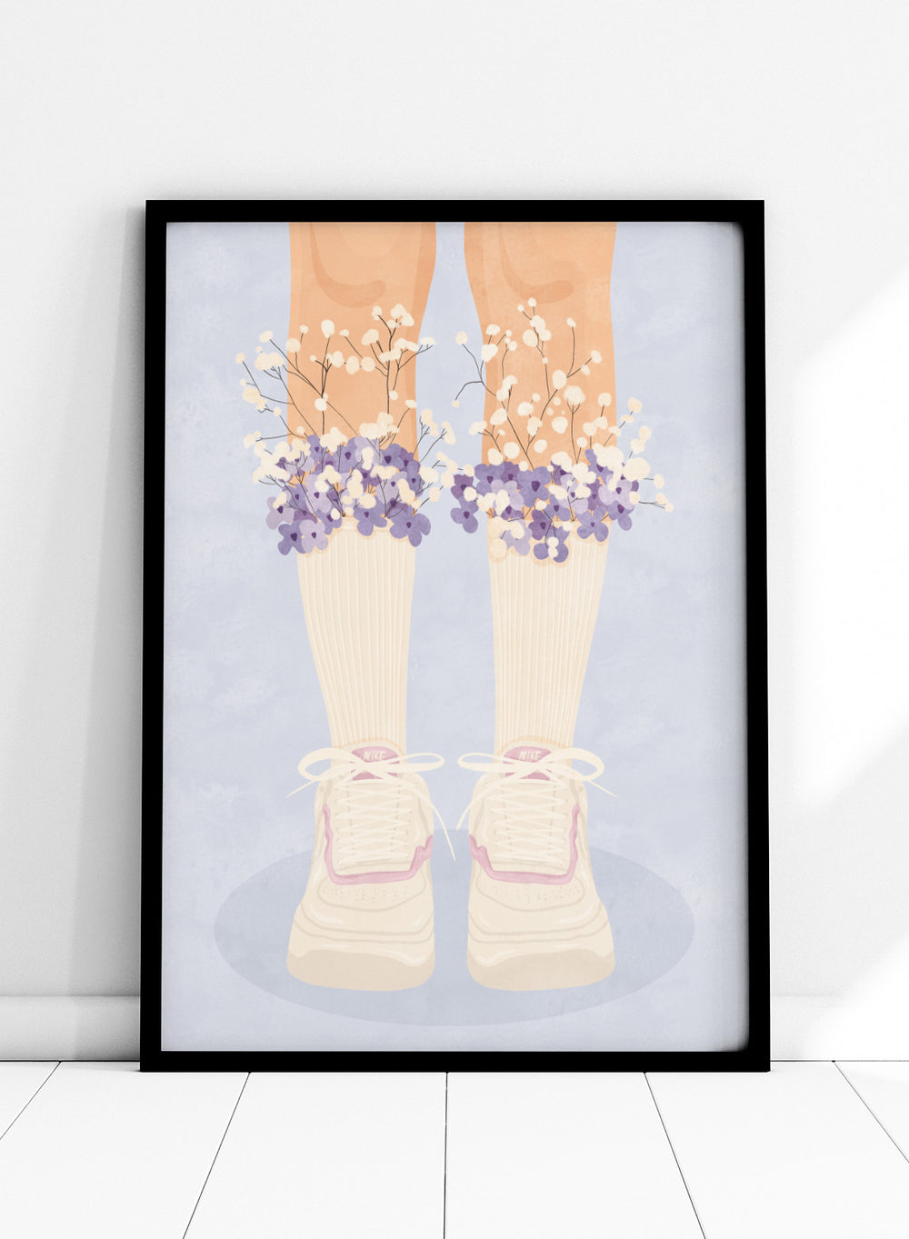 A stylized illustration of a person's legs wearing cream ribbed socks, white sneakers with pink trim, and bunches of small white and purple flowers at the top of the socks, set against a pale blue background. Floral Socks and Sneakers by Lisa Solomoniuk premium framed fine art print featuring cream sneakers with purple and white flowers.