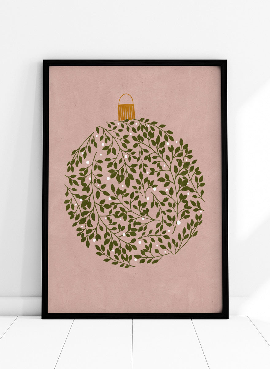 Shop Round Ornament by Katie O’Shea, a botanical Christmas wall art print poster featuring green leaves, white glowing light details, and a dusty pink background.