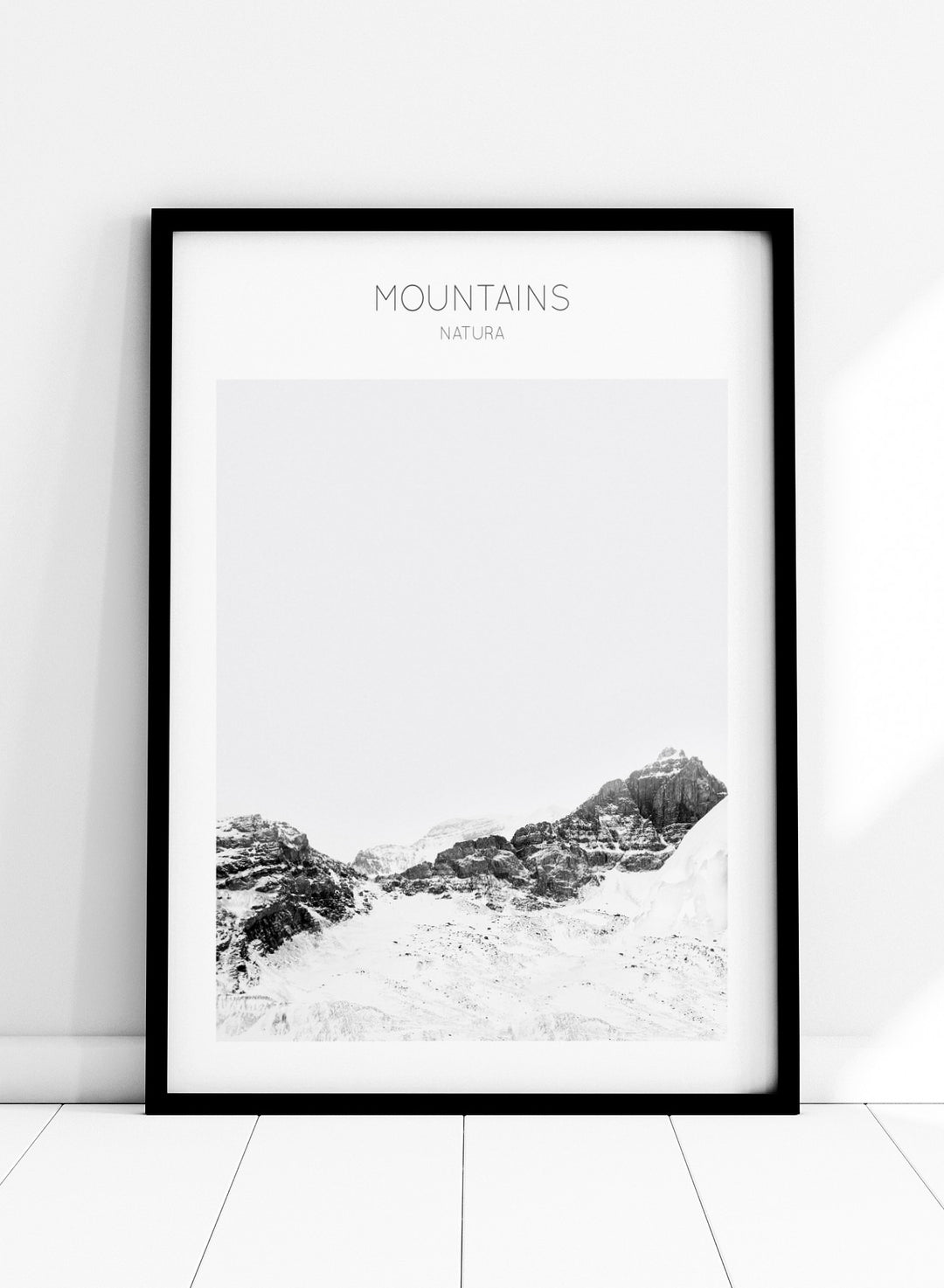 Black and white mountain landscape with 'Mountains Natura' text. Serene Peaks by The MIUUS Studio is a black and white mountain photography art print and wall poster featuring snowy peaks, minimalist composition, and modern neutral design.