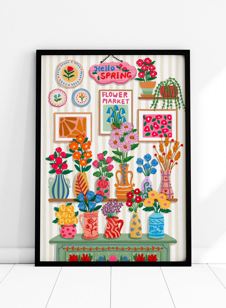A colorful spring-themed floral wall display illustration featuring vases, framed art, hanging plants, and a sign reading &