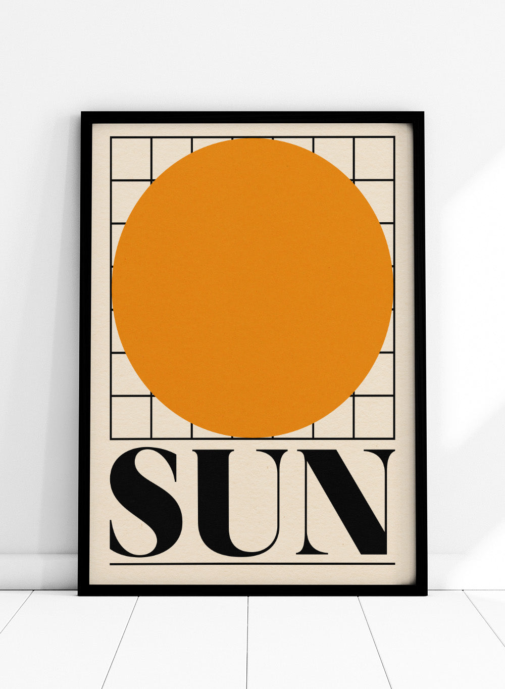 Poster with a large orange circle and the word 'SUN' on a beige background. Sun by Rosi Feist is a bold minimalist Bauhaus-inspired art print featuring an orange circle and graphic grid. Officially licensed modern poster with framing.