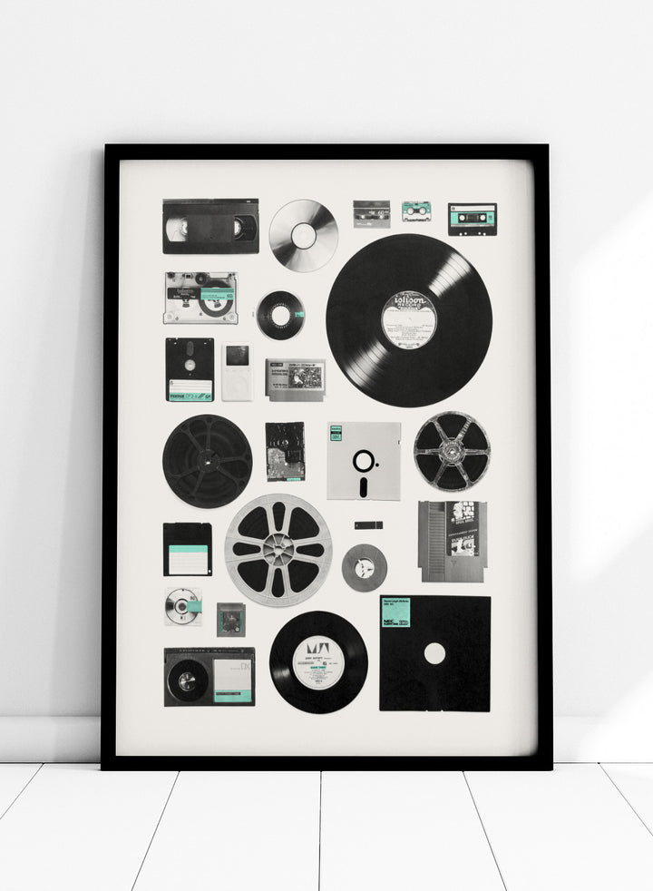 Collection of vintage audio and video equipment on a white background. Analog Digital Memories by Florent Bodart is a retro media art print featuring vinyl, cassette, and floppy disks, a modern wall poster exploring analog and digital design.