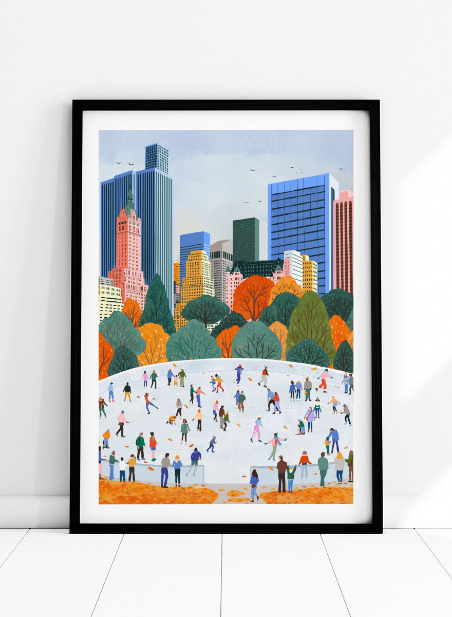 A framed art print depicting a city skyline with autumn trees and a large white ice rink filled with small illustrated people skating. Autumn City Ice Skating by Ceyda Alasar city art print featuring a lively outdoor rink, fall trees, skaters, and a colorful urban skyline.