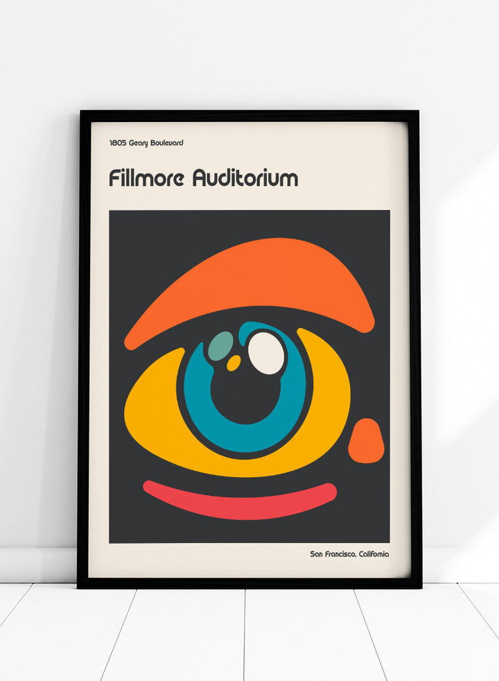 A poster-style graphic for the Fillmore Auditorium in San Francisco, California, featuring an abstract eye illustration in orange, yellow, blue, red, and white on a dark gray square, with cream margins and black text reading &